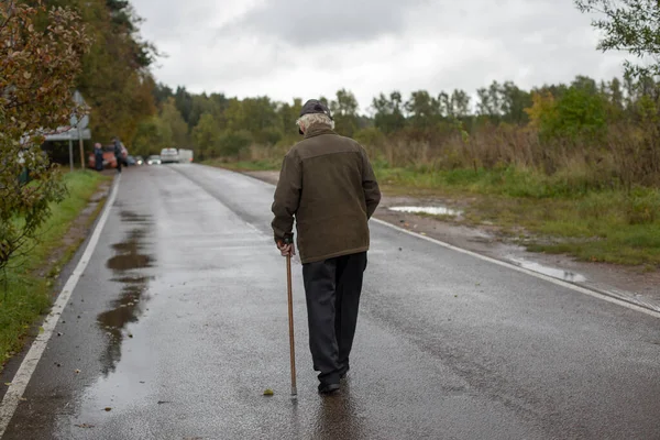 depositphotos 544605950 stock photo old man walks road pensioner